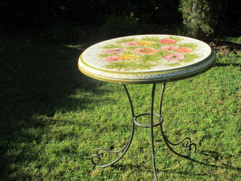 Tuscan round table with ceramic top and wrought iron base in anemone pattern